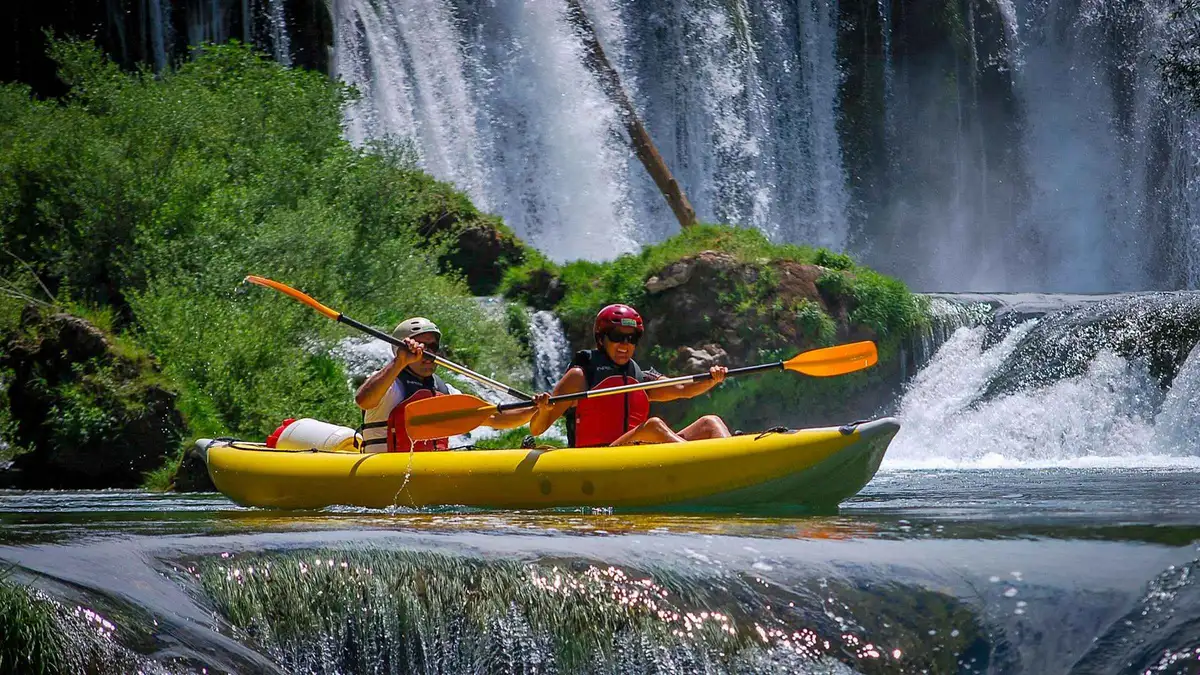 Kayaks on the emerald Zrmanja beneath the white canyon walls