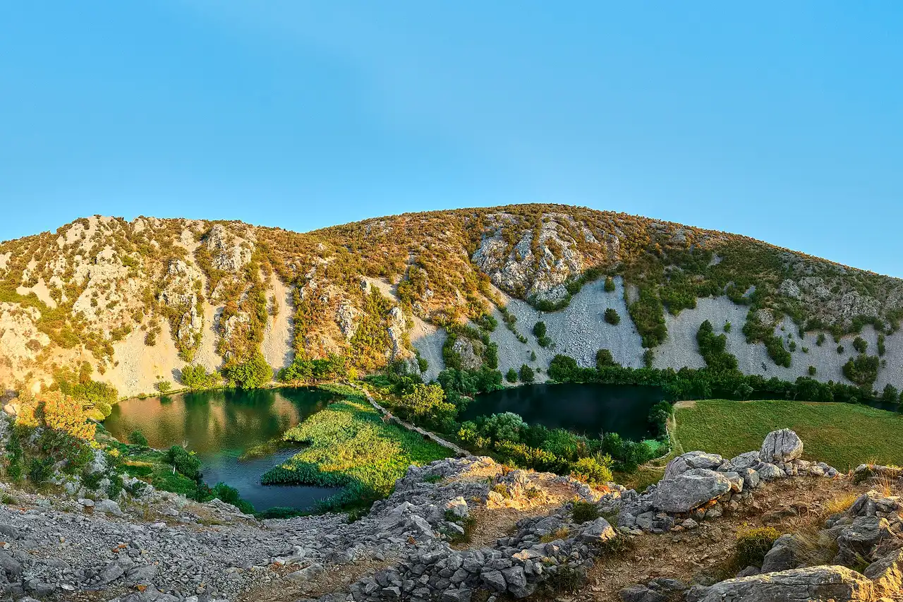 Emerald water of the Zrmanja river running between white limestone canyon walls